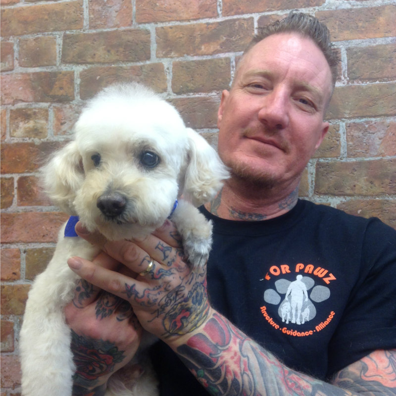 Owner Scott Grasman hugging a dog